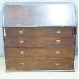 A 19thC oak and pine bureau with fitted interior and four graduated drawers with brass campaign