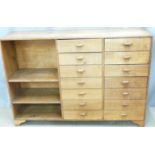 An oak shopfitting/haberdashery counter with fourteen drawers and shelves, W131 D35 H92
