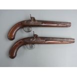 A pair of percussion hammer action holster pistols with engraved locks, hammers, top straps and