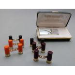 Three pairs of shotgun cartridge cufflinks and a money clip with pheasant decoration