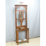 An oak hall stand, with bevelled glass mirror and metal wells, W65 D27 H200cm