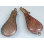 A copper and brass powder flask with embossed decoration to both sides together with a leather and