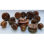 Fifteen vintage wooden and brass fishing reels including some with early ratchet mechanism, drag and