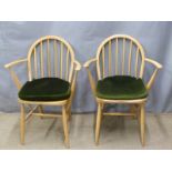 A pair of retro light elm Ercol armchairs