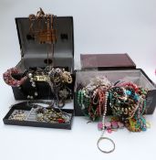 A collection of costume jewellery including beads, in jewellery boxes