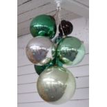 Six glass witch's balls or oversized baubles, diameter of largest approximately 25cm, and a small