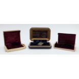 Three Bulova wristwatch boxes comprising one Art Deco example with gold and cream exterior and '