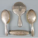 Hallmarked silver four piece dressing table set comprising hand mirror and three brushes