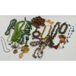 A collection of beaded necklaces including carved wood, ceramic, amber, agate etc