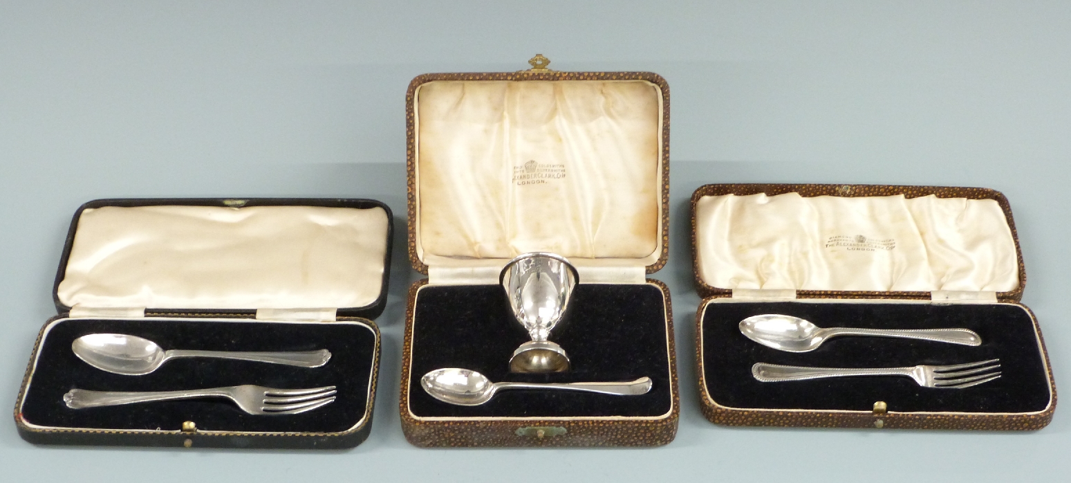 Two cased hallmarked silver fork and spoon sets and a cased hallmarked silver egg cup and spoon set,