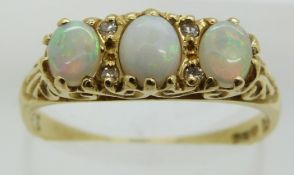 An 18ct gold ring set with three opals and diamonds, 3.6g, size P/Q