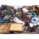 A collection of costume jewellery including white metal bangle, beads, necklaces, watches,