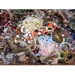A collection of costume jewellery including vintage bangles, a silver bangle, pearl necklace,
