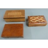 Two parquetry inlaid boxes, width of larger 25cm, together with a cased set of brass weights