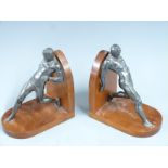 Pair of book ends formed as cast metal figures leaning backwards, H20cm