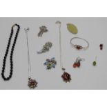 A collection of silver and pressed amber jewellery including earrings, bangle, pendant and other