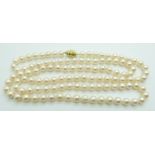 A single strand cultured pearl necklace with 14k gold clasp set with a diamond