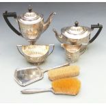 Three piece hallmarked silver dressing table set comprising hand mirror and two brushes together