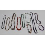 A collection of beaded necklaces including amethyst, glass, agate etc