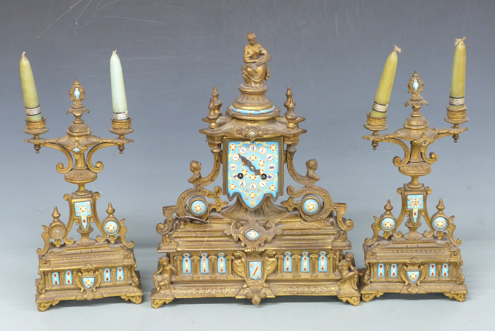 French brass figural clock garniture with enamelled decoration, 43cm tall