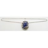 A large sapphire cabochon (150ct) set into a bespoke silver pendant setting, on silver chain