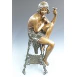 Art Deco style bronze/bronzed flapper girl with champagne glass seated on an ornate Art Nouveau