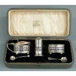 George V cased three piece hallmarked silver cruet set with blue glass liners, Birmingham 1920 maker