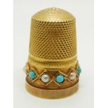 A yellow metal thimble set with pearls and turquoise in original box