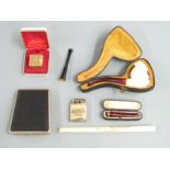 Cased Meerschaum pipe with carved bust decoration, cased cherry amber and 9ct gold cheroot holder,