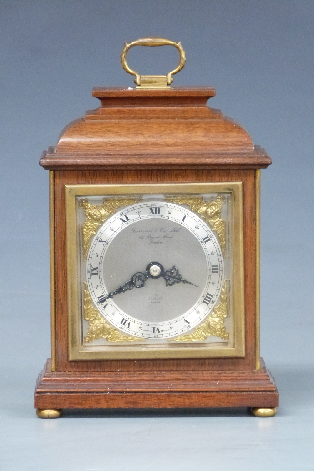 Elliott mantel clock in bell top mahogany case, the silvered Roman chapter ring with gilt cherub