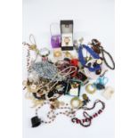 A collection of costume jewellery including beads, earrings, Anne Klein watch, glass beads etc