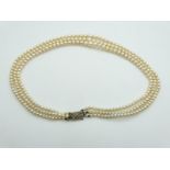 A three strand pearl necklace with 9ct white gold clasp set with a diamond