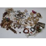 A collection of jewellery including amber bracelet, Exquisite brooch, vintage brooches, necklaces
