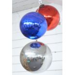 Three glass witch's balls or oversized baubles, diameter of largest approximately 28cm