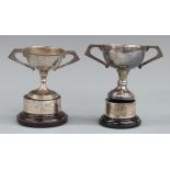 Two hallmarked silver trophy cups on stands, each approximately 10cm tall, weight without stands