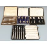 Two cased sets of hallmarked silver handled knives, one by Viners together with two cased sets of