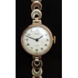 Consul 9ct gold ladies wristwatch with black hands and Arabic numerals, silver dial and 17 jewel