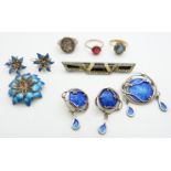 A silver brooch set with blue enamel with matching earrings, a silver brooch in the form of a flower