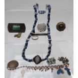 A collection of jewellery including beads, glass necklace, brooches including Victorian, Miracle,