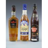 Three bottles of golden rum comprising Brugal Ron Anejo, 700ml, 38% vol, in original netting,