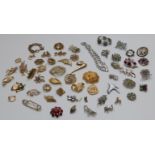 A large collection of vintage brooches including Monet, Hollywood, Sphinx, marcasite and paste, a