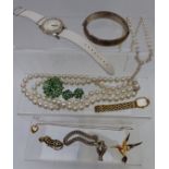 A collection of jewellery including rolled gold locket, silver bangle, brooches, Accurist watch,