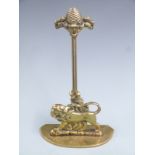 19thC brass door stop/porter with figural lion decoration and pineapple finial