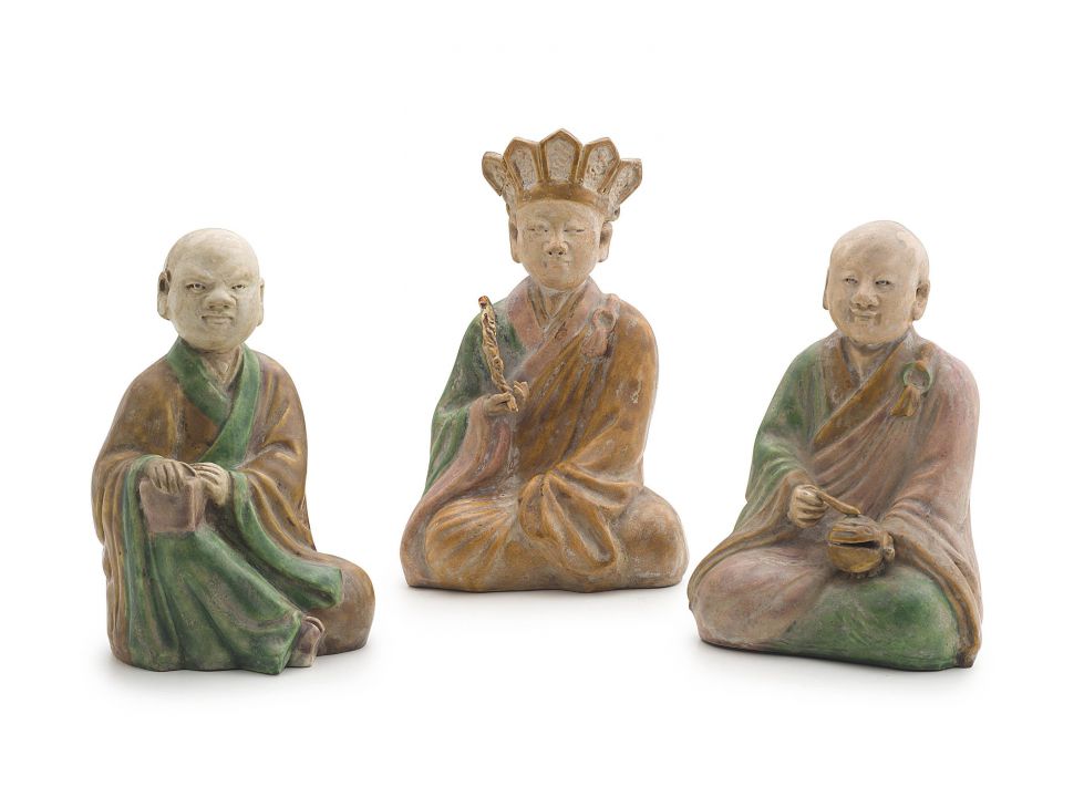 Three Chinese Ming style sancai-glazed stoneware figures of two monks and a deity, 20th century