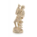A tall Japanese ivory okimono of a reveller and a child, Meiji period, 1868-1912