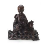 A Chinese carved hardwood figure of a scholar, 20th century