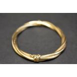 A 9ct twisted gold hinged bangle,11.6g.
