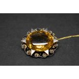 An filigree oval citrine brooch, total weight 17.5g.