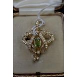 A cased Edwardian 15ct gold brooch/pendant set octagonal peridot and split pearls, 29mm wide,