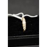 An unmarked yellow metal diamond half hoop ring, total weight 2.3g.